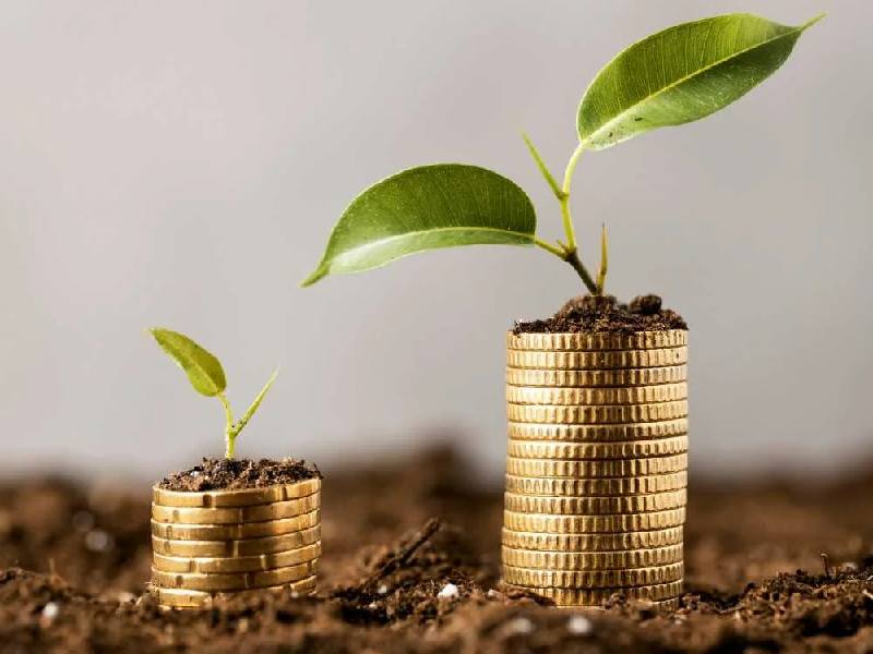 Cute asian little girl playing with coins making stacks of money,kid